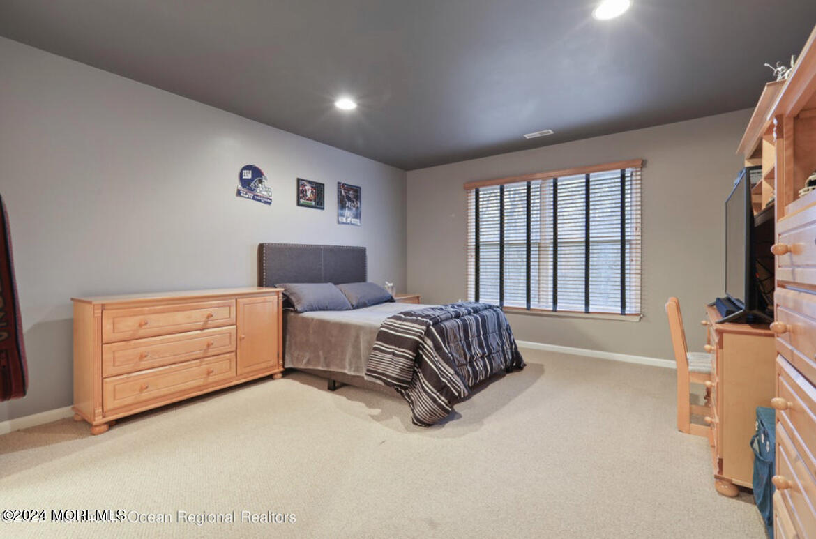 29 Northwoods Road Asbury Park, NJ 07712 - Photo 25 of 34 a spacious bedroom with a bed and a dresser