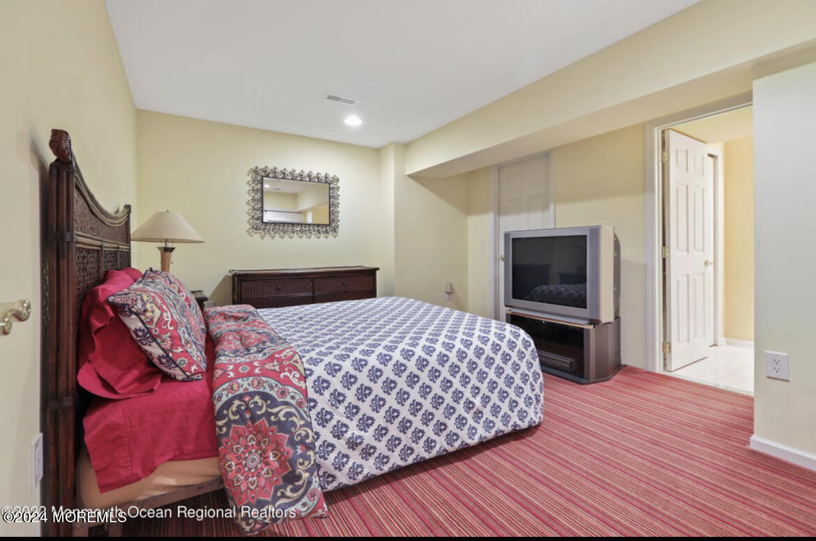 29 Northwoods Road Asbury Park, NJ 07712 - Photo 26 of 34 a bedroom with a large bed and a tv