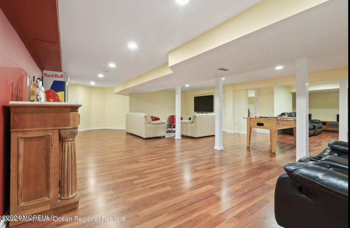 29 Northwoods Road Asbury Park, NJ 07712 - Photo 28 of 34 a living room with furniture and kitchen view with wooden floor