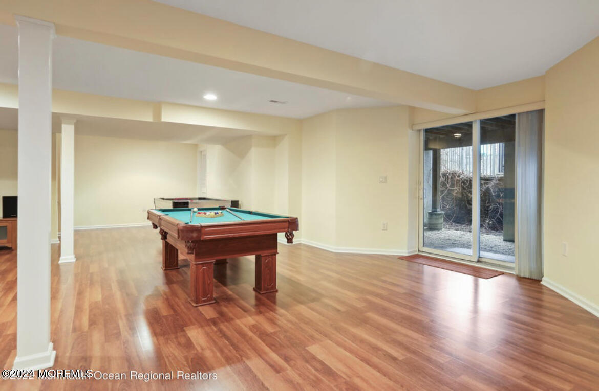 29 Northwoods Road Asbury Park, NJ 07712 - Photo 29 of 34 a room with wooden floor and a table