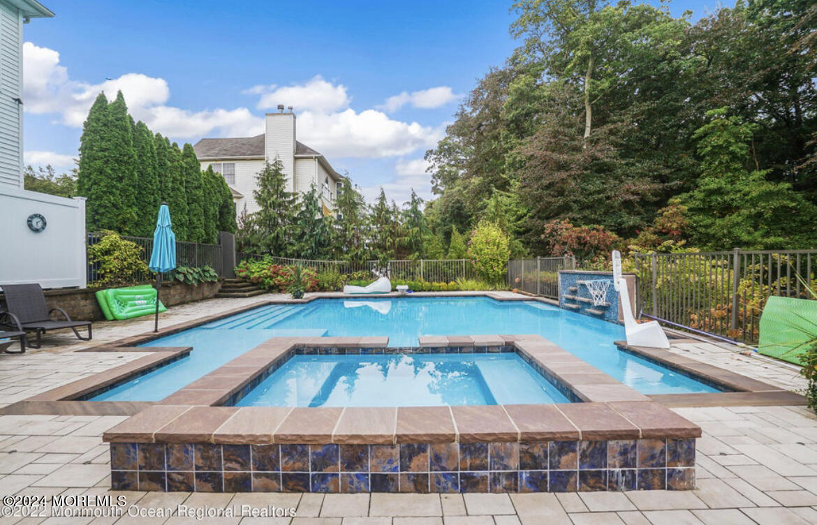 29 Northwoods Road Asbury Park, NJ 07712 - Photo 3 of 34 a view of a swimming pool with a lounge chairs