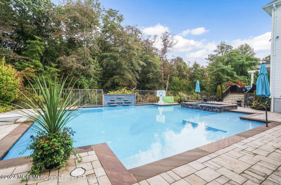 29 Northwoods Road Asbury Park, NJ 07712 - Photo 4 of 34 a view of a swimming pool with chairs