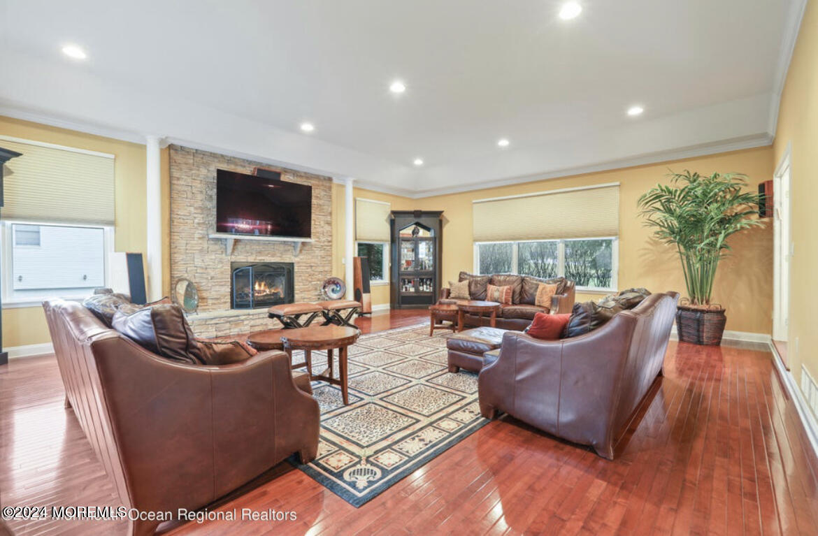 29 Northwoods Road Asbury Park, NJ 07712 - Photo 10 of 34 a living room with fireplace furniture and a flat screen tv