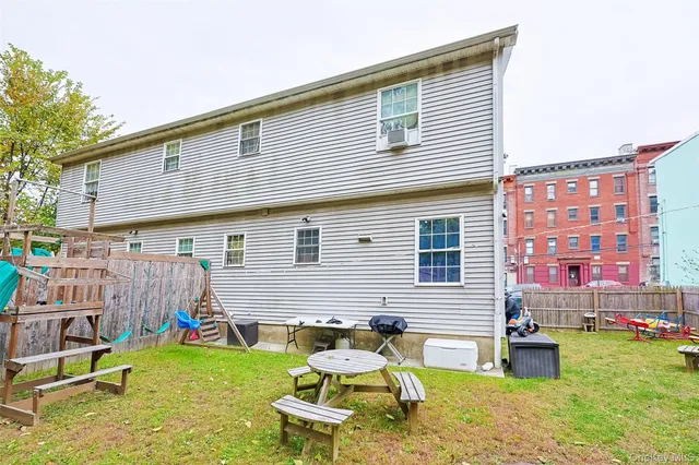 a view of backyard with a table and chairs