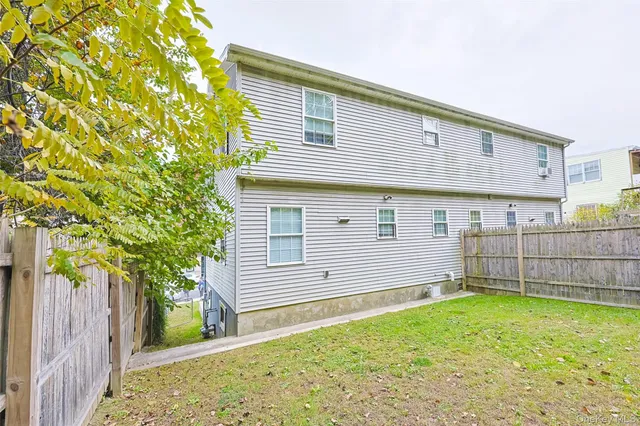 a view of backyard with a table and chairs