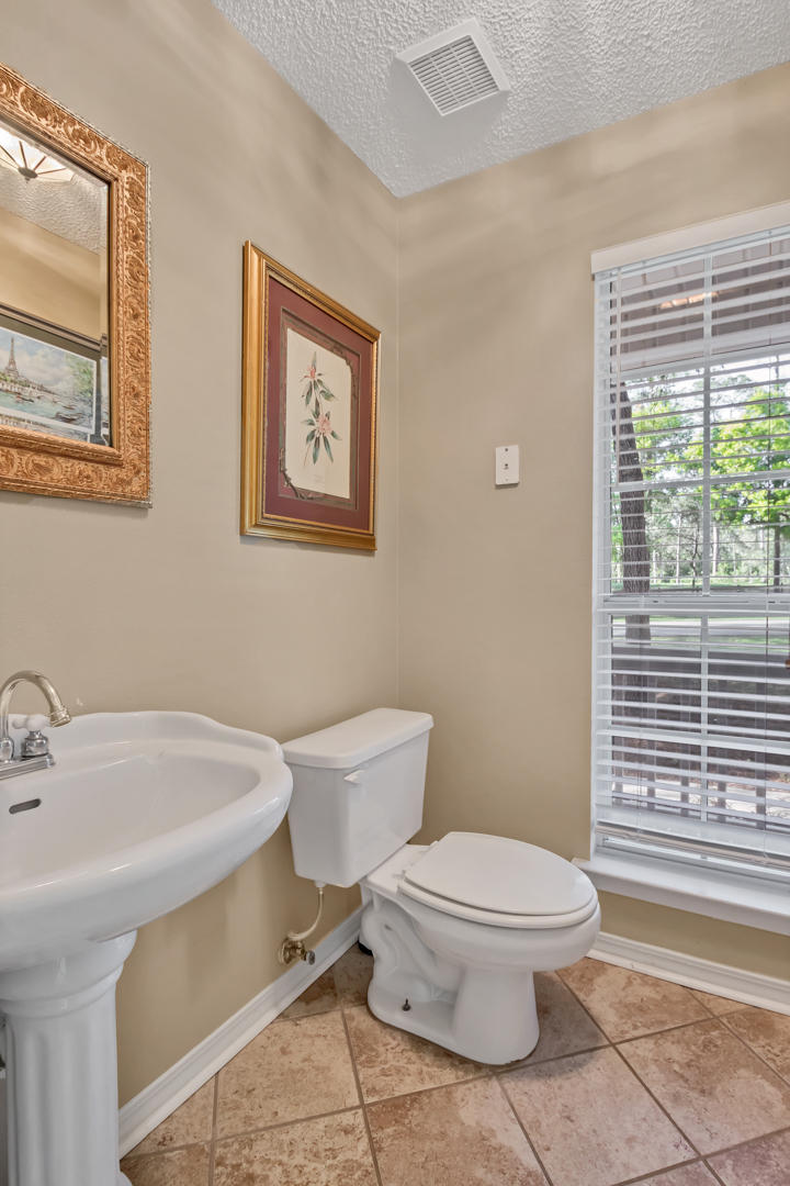 1830 Huntington Road Niceville, FL 32578 - Photo 14 of 35 a white toilet sitting next to a bathroom sink
