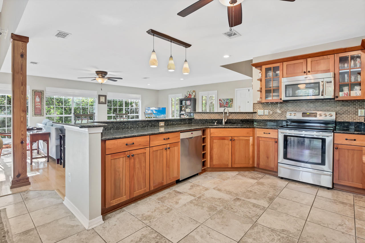 1830 Huntington Road Niceville, FL 32578 - Photo 10 of 35 a kitchen with stainless steel appliances granite countertop a stove sink and cabinets