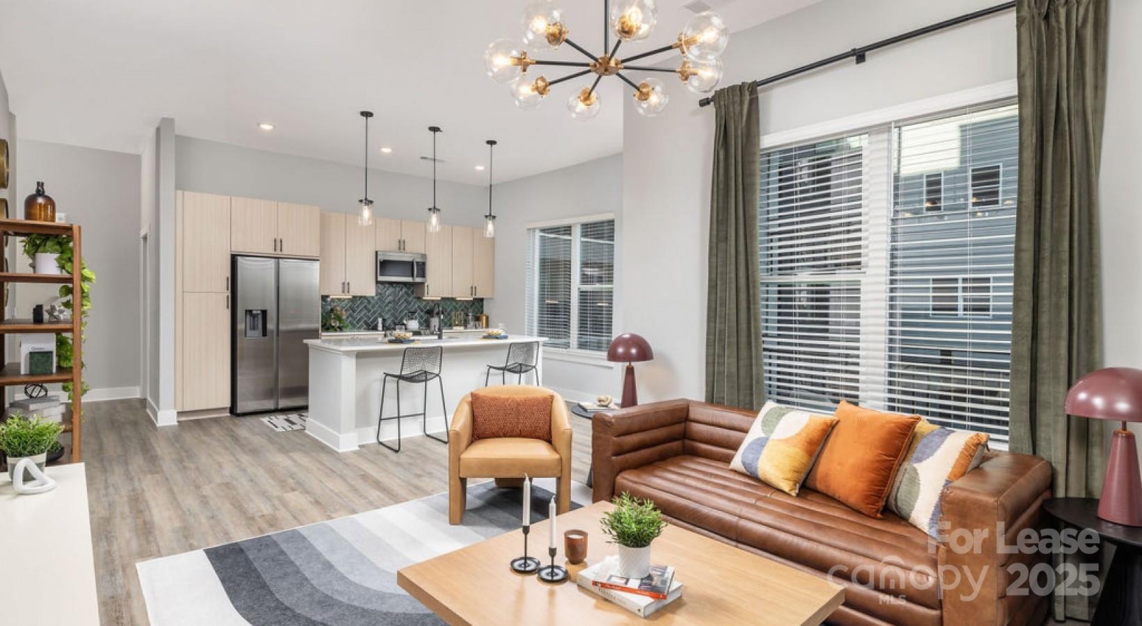 1015 North Alexander Street, Unit B5 Charlotte, NC 28206 - Photo 2 of 31 a living room with furniture kitchen view and a large window