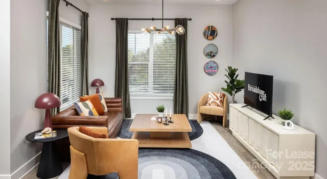 a kitchen with stainless steel appliances a dining table chairs and refrigerator