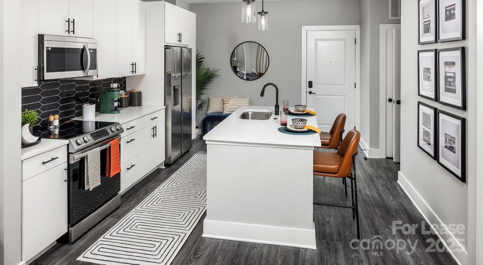 1015 North Alexander Street, Unit B5 Charlotte, NC 28206 - Photo 30 of 31 a kitchen that has a sink a stove and a wooden floor