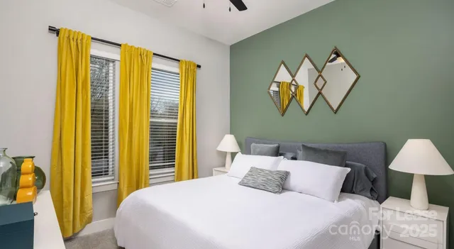 a bedroom with a bed and a painting on the wall