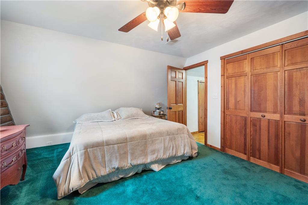 215 Shilo Ridge Drive Export, PA 15632 - Photo 20 of 48 a bedroom with a bed and a chandelier