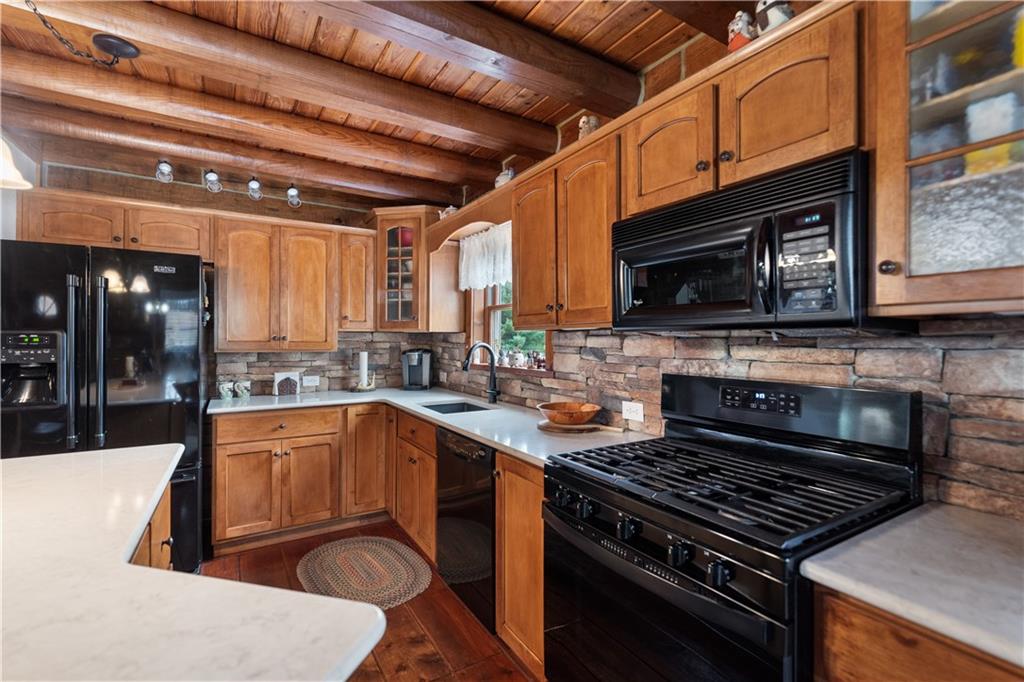 215 Shilo Ridge Drive Export, PA 15632 - Photo 8 of 48 a kitchen with stainless steel appliances granite countertop a stove top oven a sink dishwasher a dining table and chairs with wooden floor