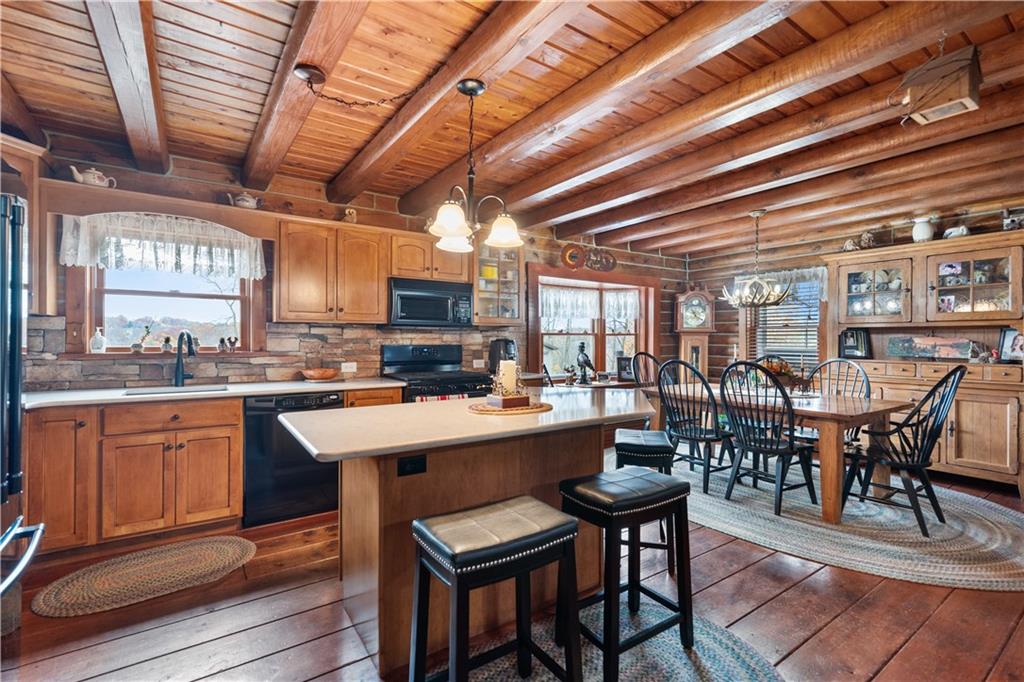 215 Shilo Ridge Drive Export, PA 15632 - Photo 10 of 48 a kitchen with lots of wooden furniture a table and chairs