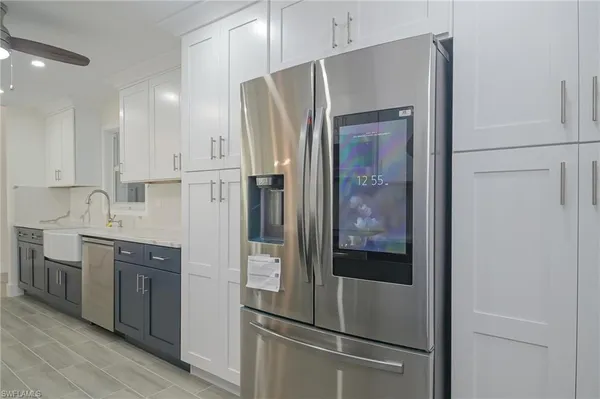a kitchen with stainless steel appliances a refrigerator and cabinets