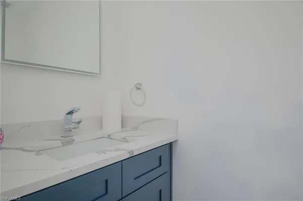 a bathroom with a sink and vanity