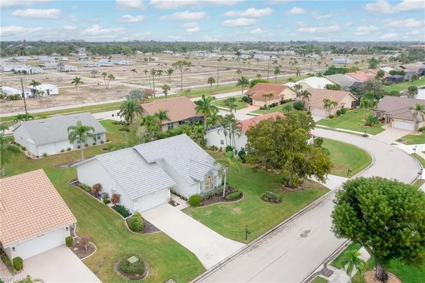 an aerial view of a house with a yard and lake view