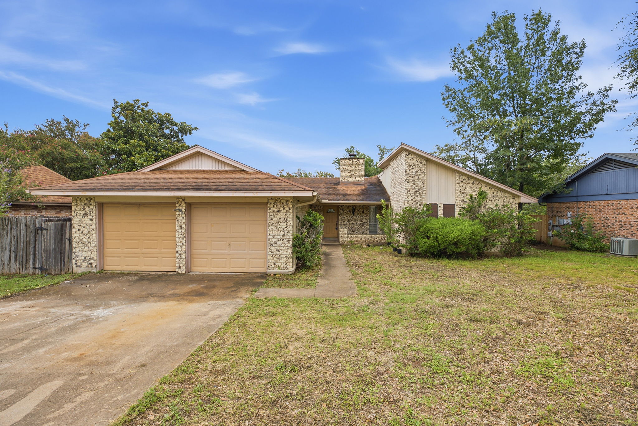 7205 Beckett Road Austin, TX 78749 - Photo 37 of 40 A charming home boasts a classic brick exterior and an attached two-car garage, offering ample parking and storage.