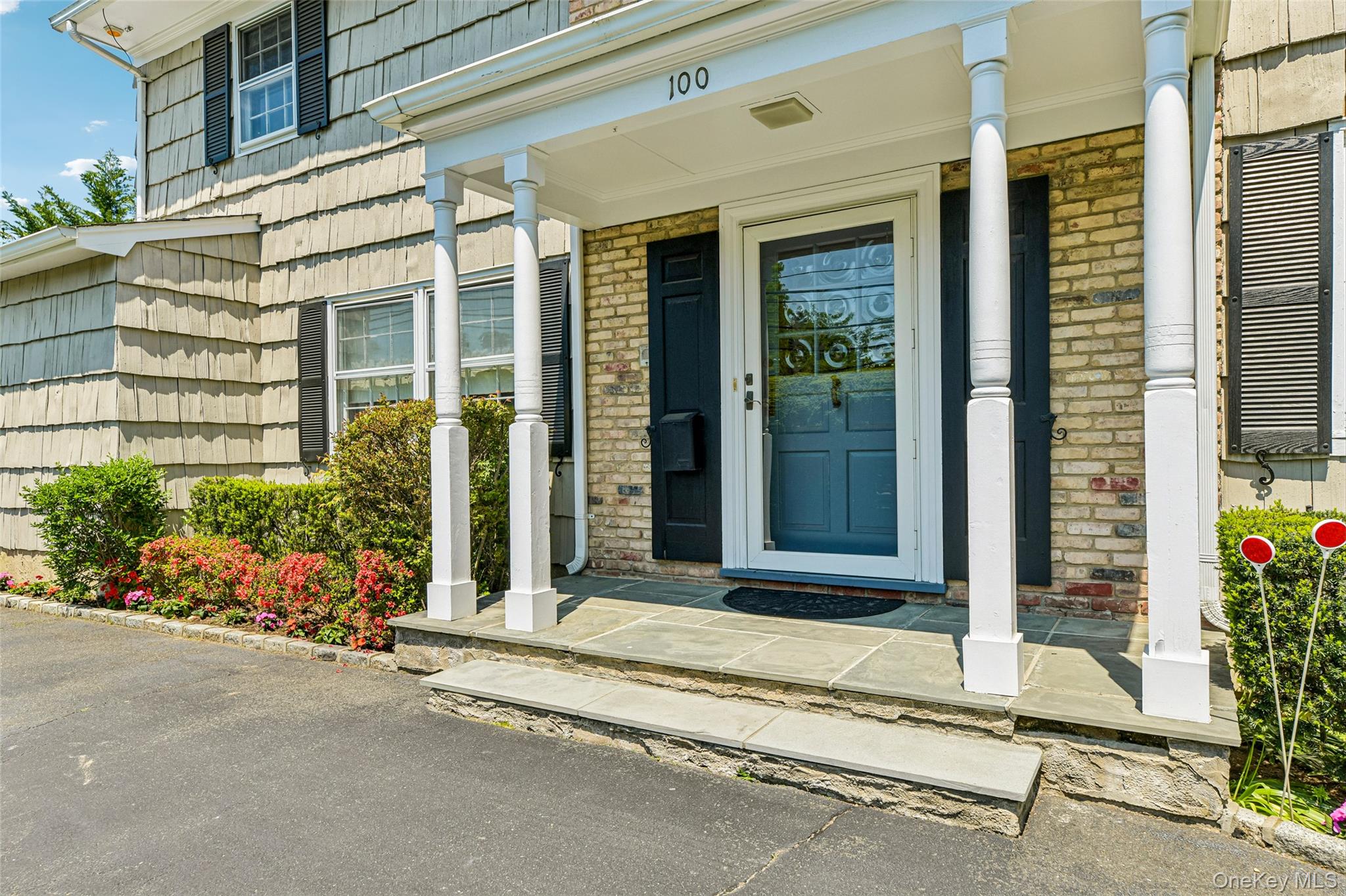 100 Hewlett Neck Road Woodmere, NY 11598 - Photo 5 of 45 a house with flowers in front of it