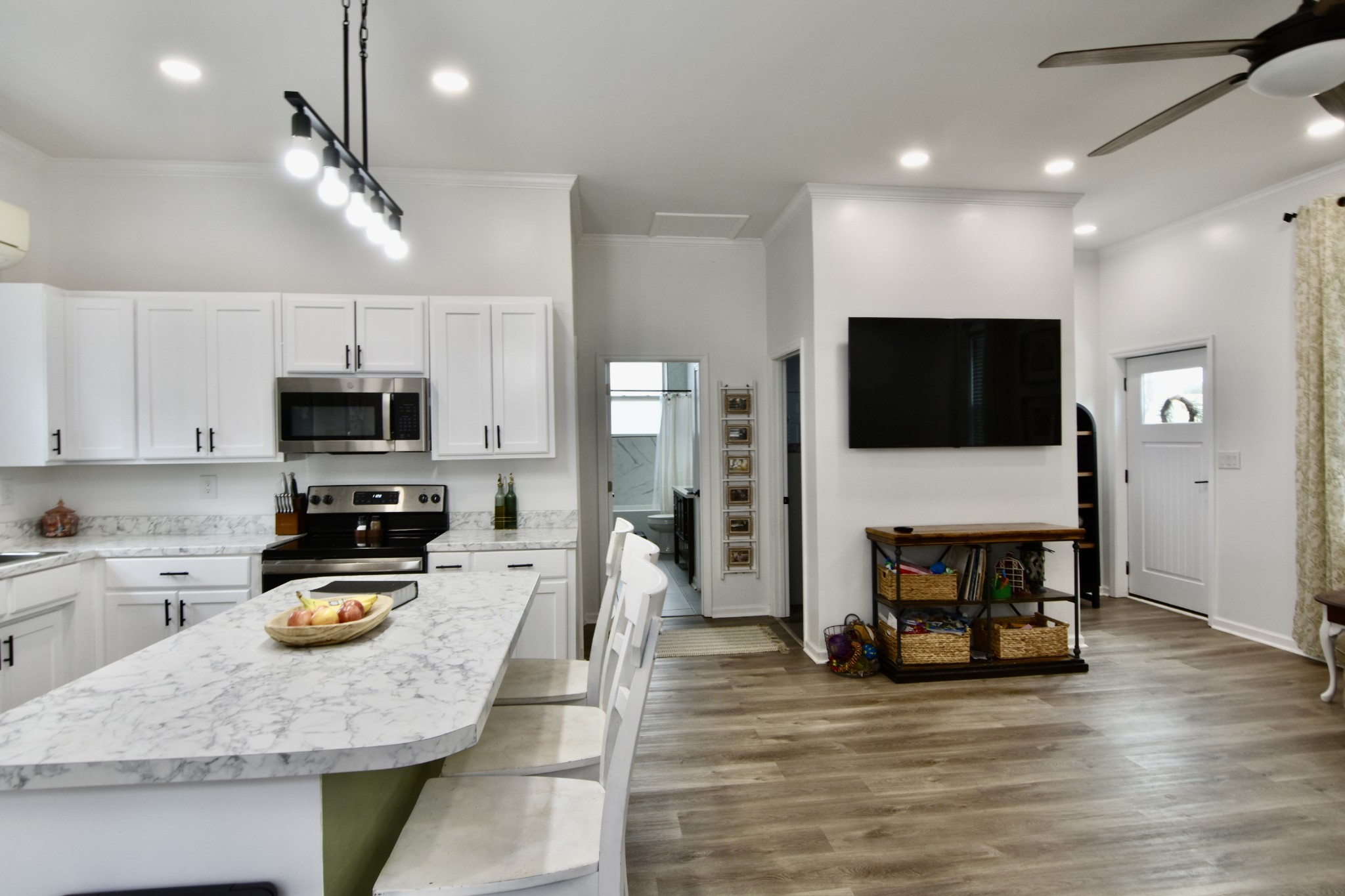 412 Eells Street Loretto, TN 38469 - Photo 12 of 19 a kitchen with stainless steel appliances a stove sink microwave and cabinets