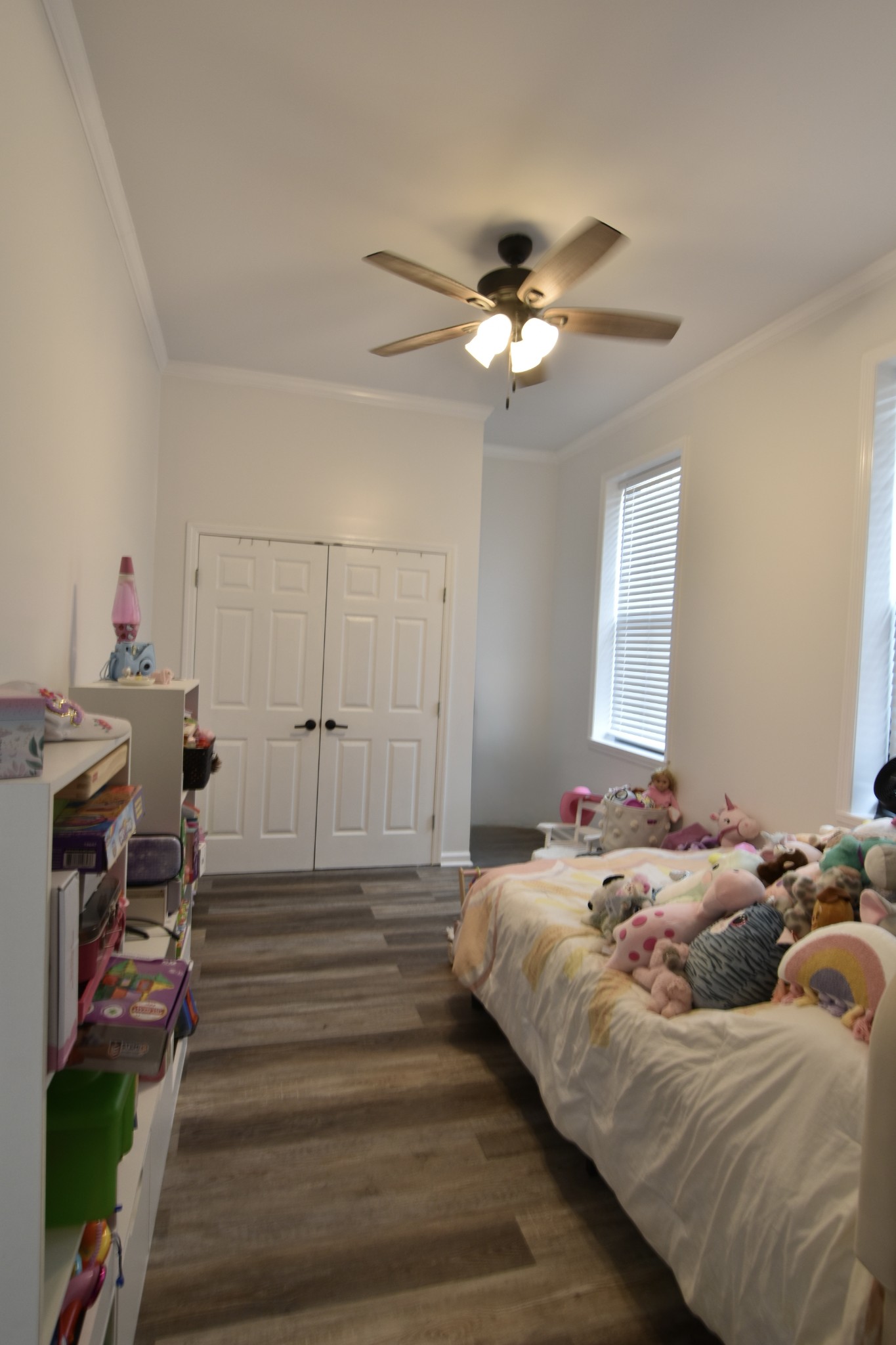 412 Eells Street Loretto, TN 38469 - Photo 17 of 19 a bedroom with a bed and a chandelier