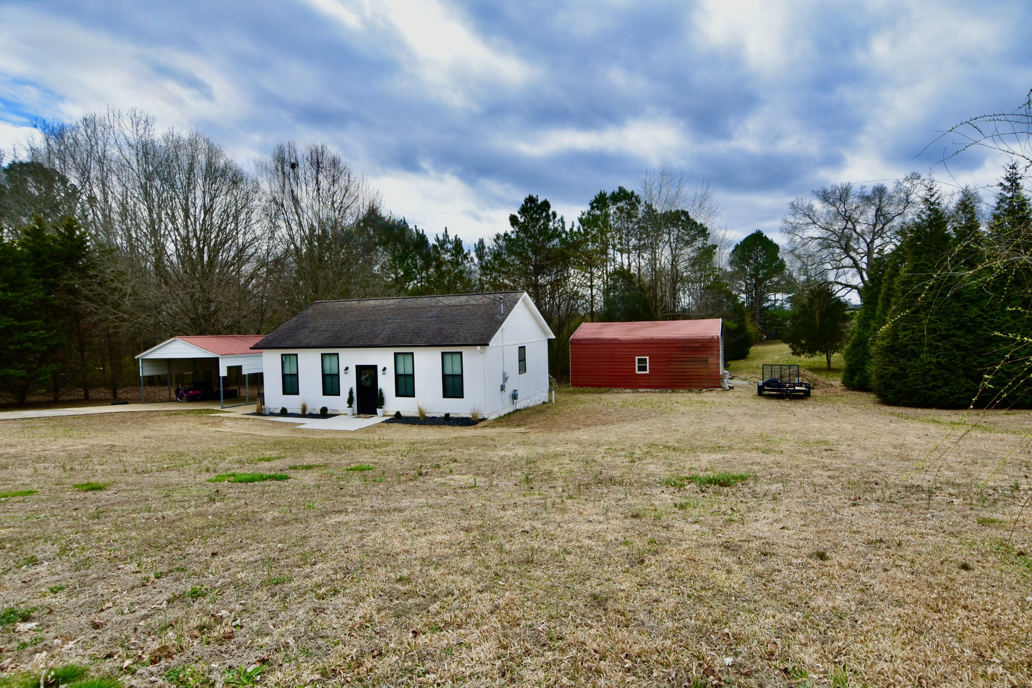 412 Eells Street Loretto, TN 38469 - Photo 2 of 19 a house with trees in front of it