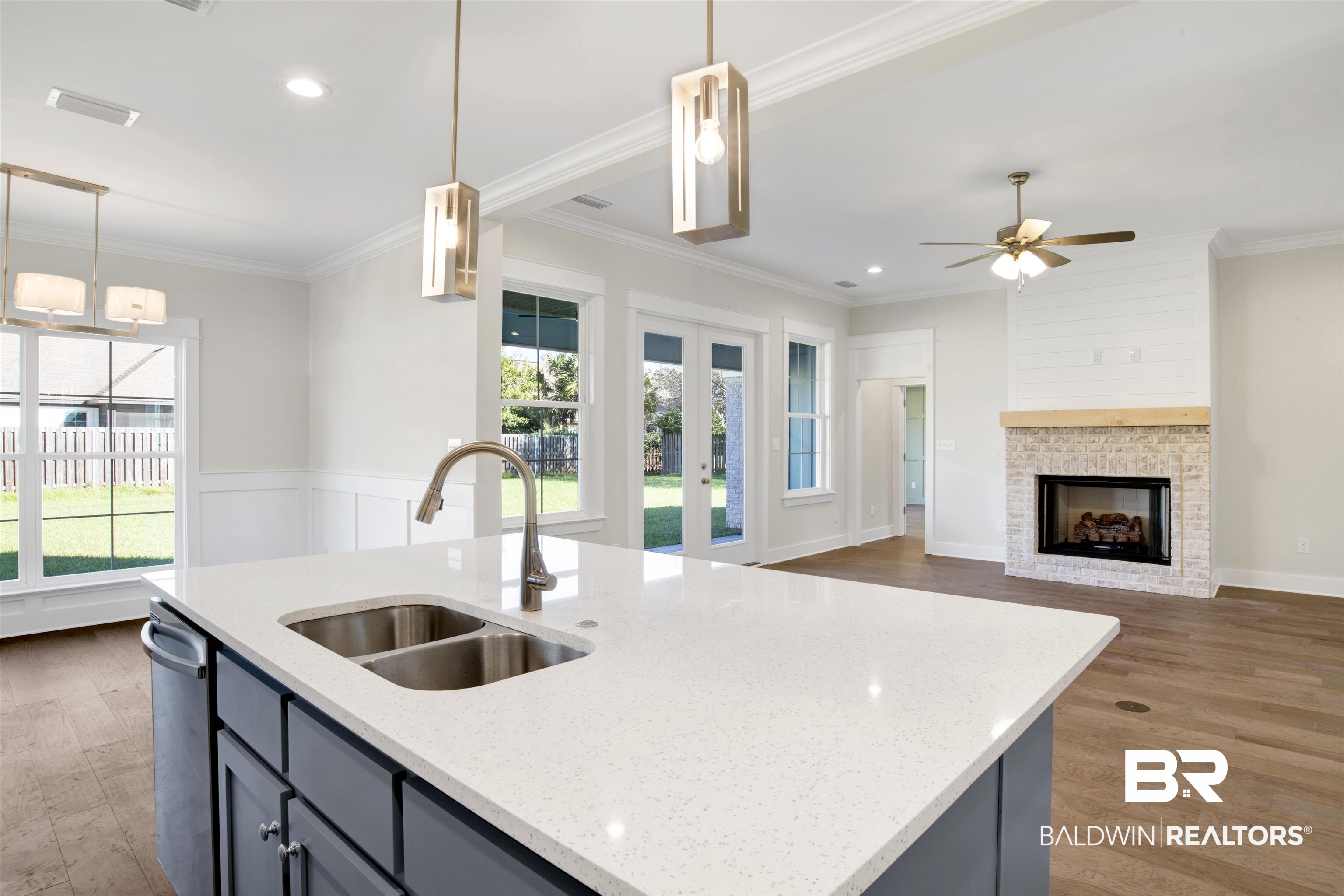 9687 Widgeon Court Daphne, AL 36526 - Photo 13 of 40 Kitchen with a wealth of natural light, light stone counters, hanging light fixtures, and sink