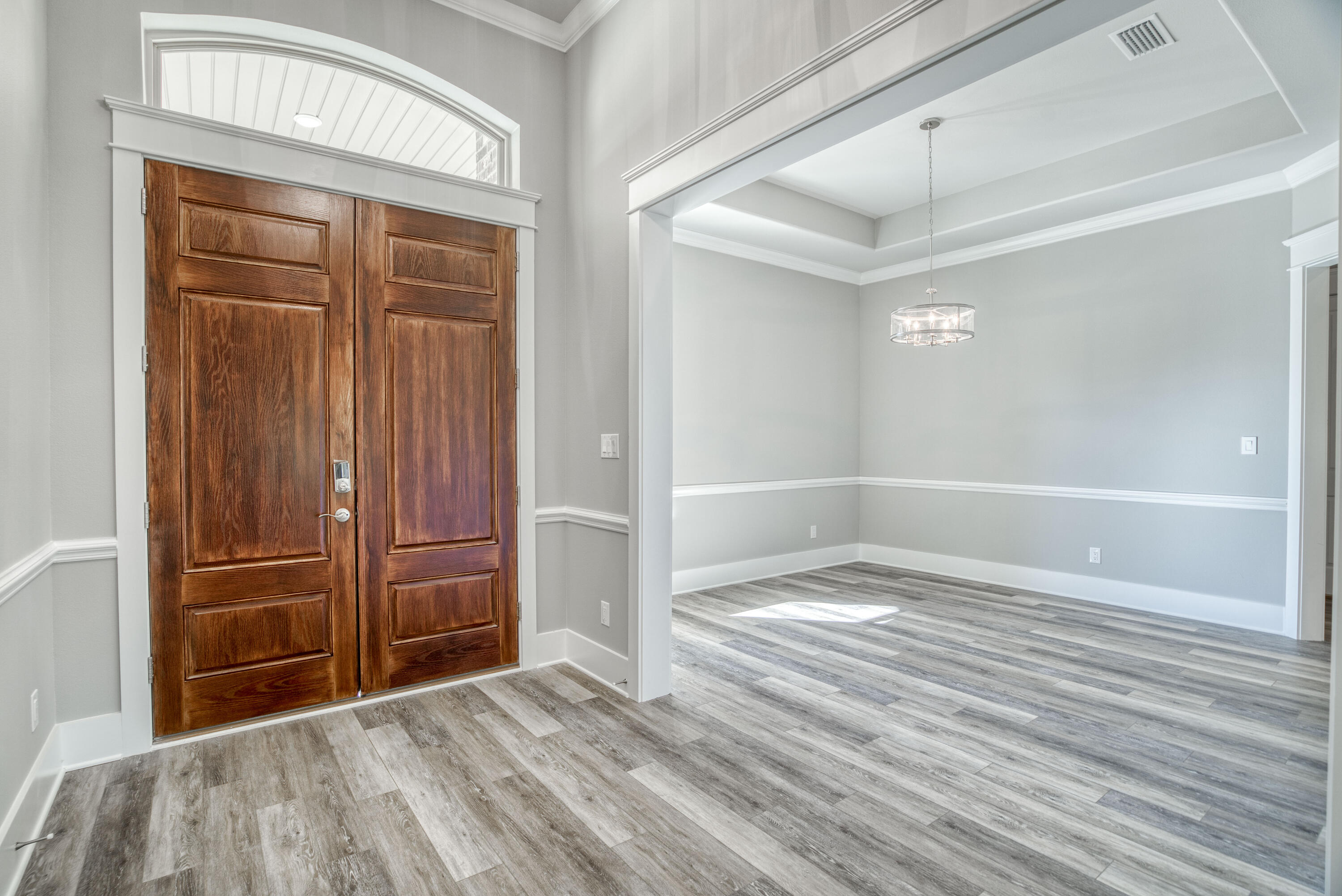 2864 P.G.A Boulevard Navarre, FL 32566 - Photo 11 of 52 wooden floor and windows in a room