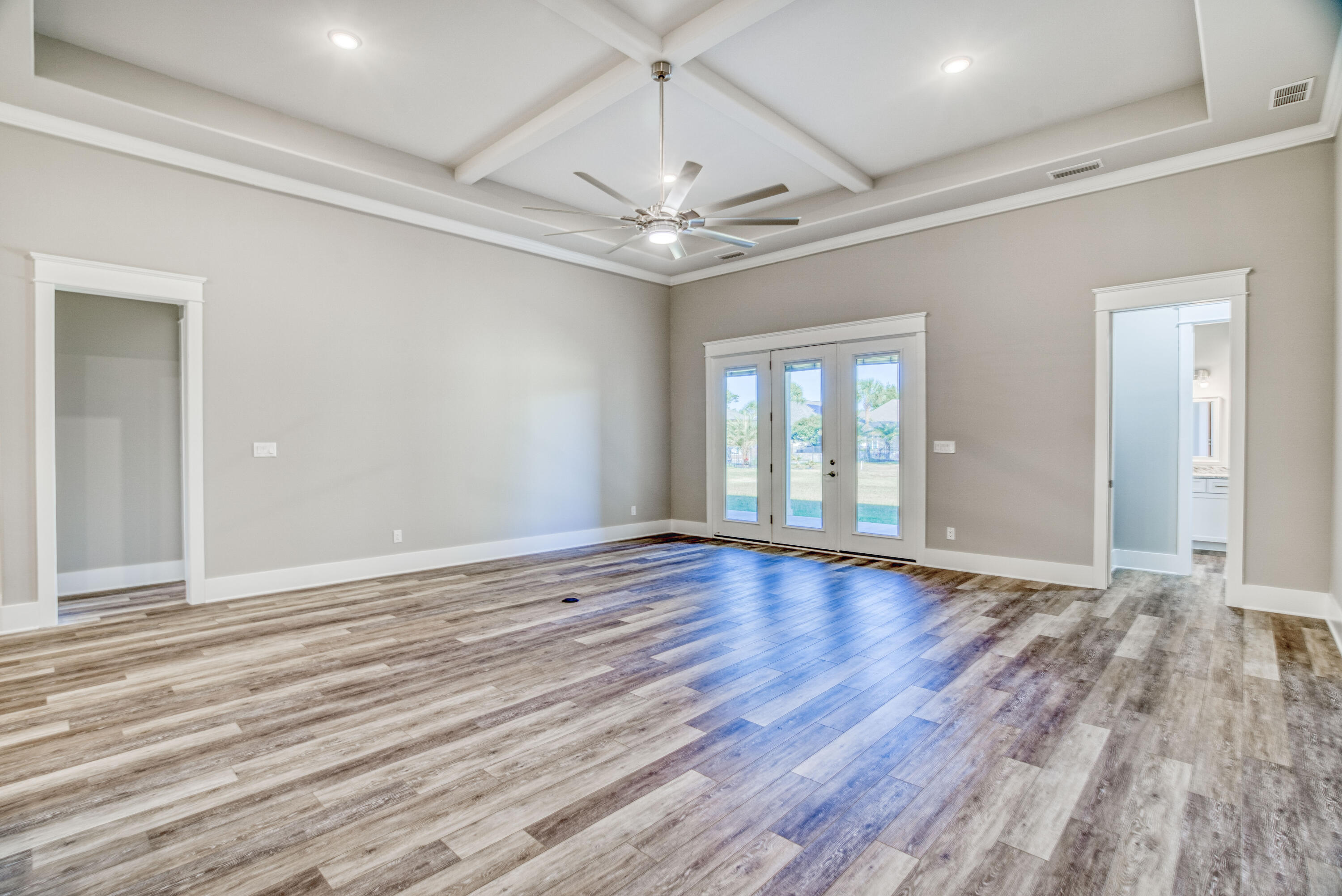 2864 P.G.A Boulevard Navarre, FL 32566 - Photo 13 of 52 a view of an empty room with wooden floor and a window