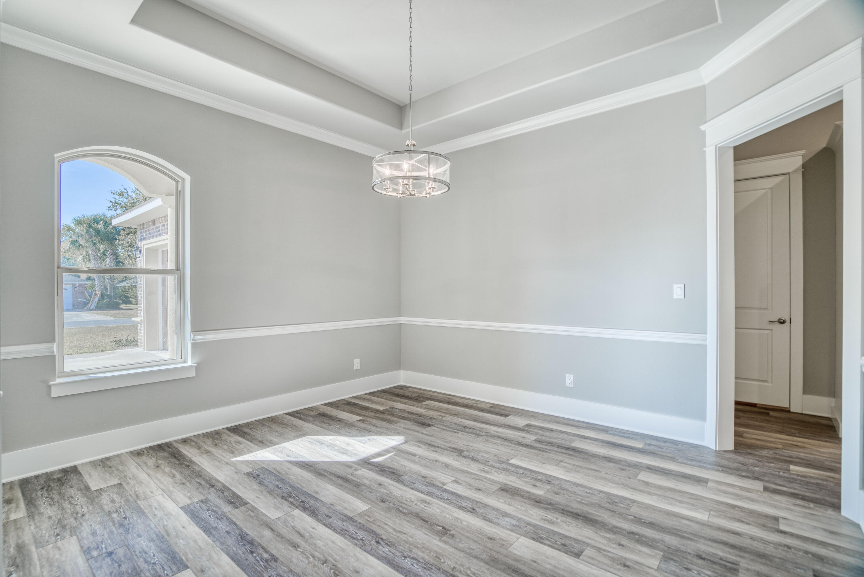 2864 P.G.A Boulevard Navarre, FL 32566 - Photo 15 of 52 wooden floor in an empty room with a window