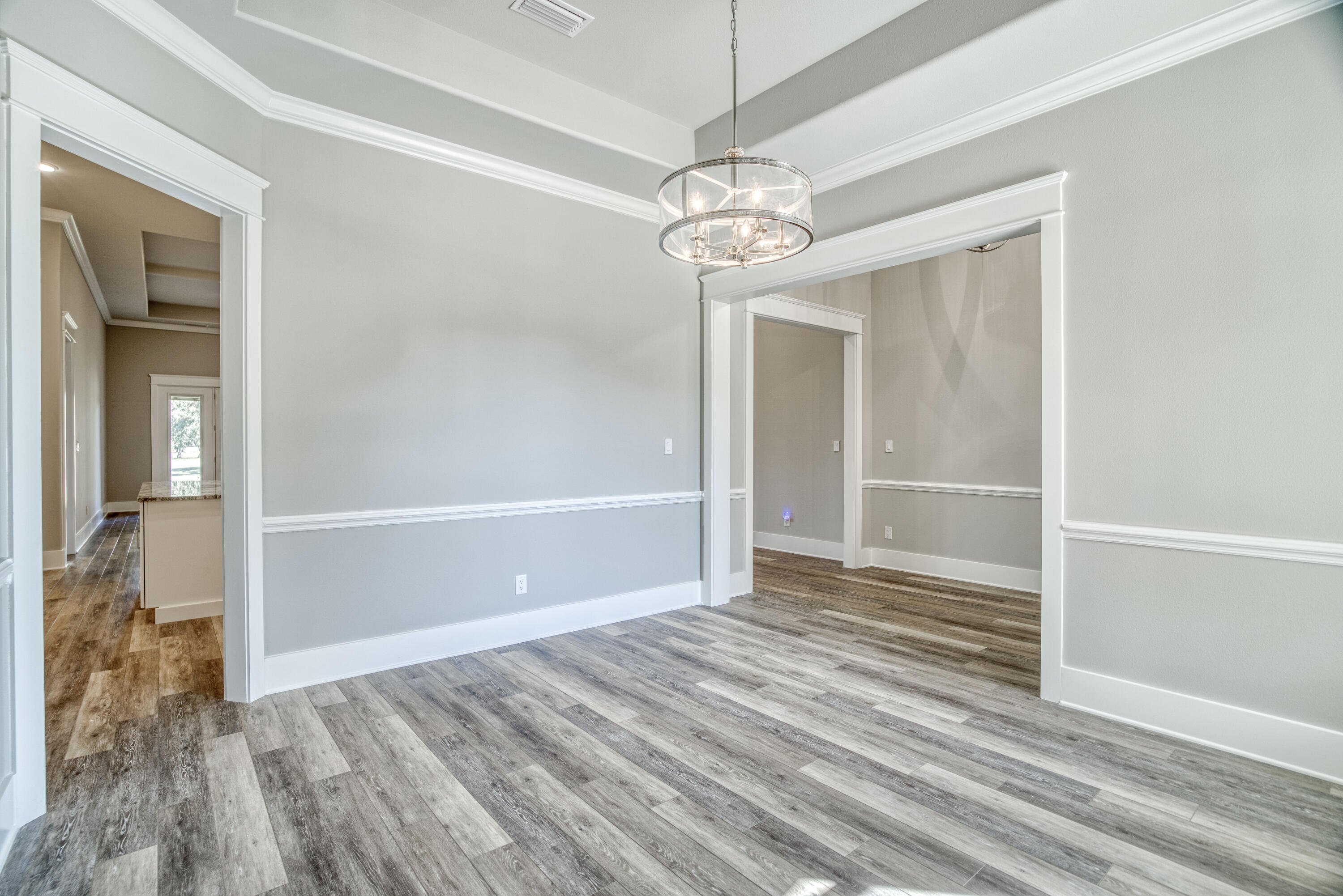 2864 P.G.A Boulevard Navarre, FL 32566 - Photo 16 of 52 a view of empty room with wooden floor and ceiling fan