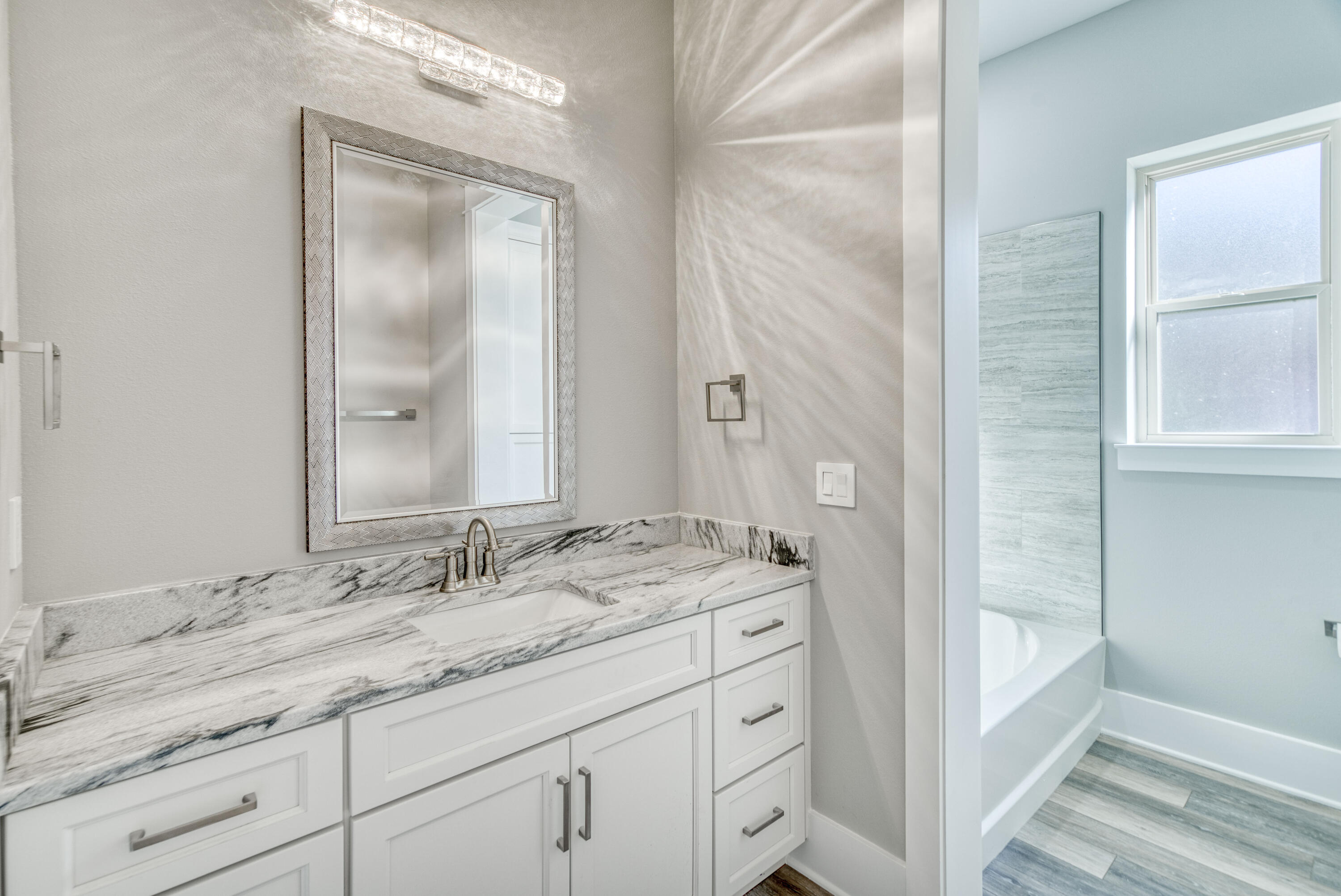 2864 P.G.A Boulevard Navarre, FL 32566 - Photo 28 of 52 a bathroom with a granite countertop sink a mirror and a