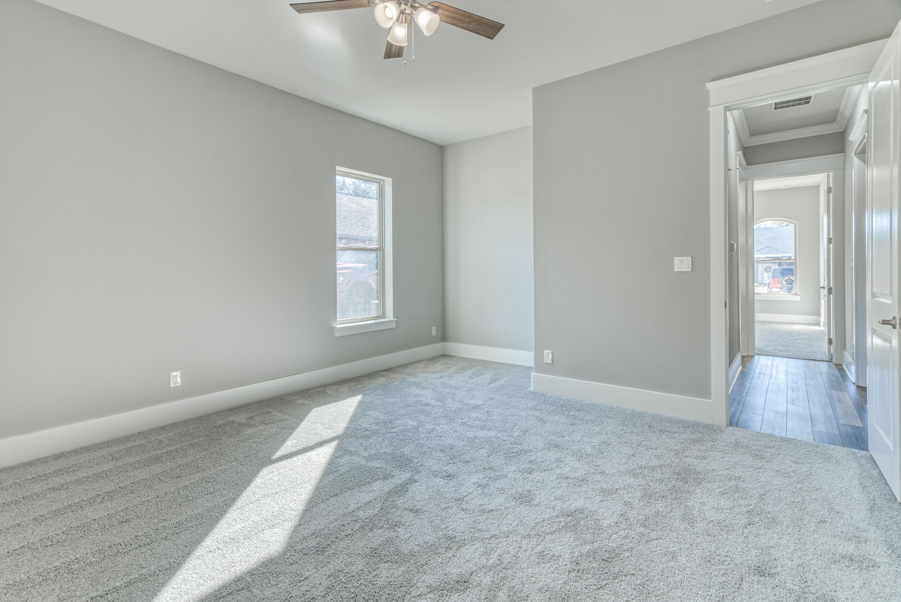 2864 P.G.A Boulevard Navarre, FL 32566 - Photo 30 of 52 an empty room with chandelier fan and windows