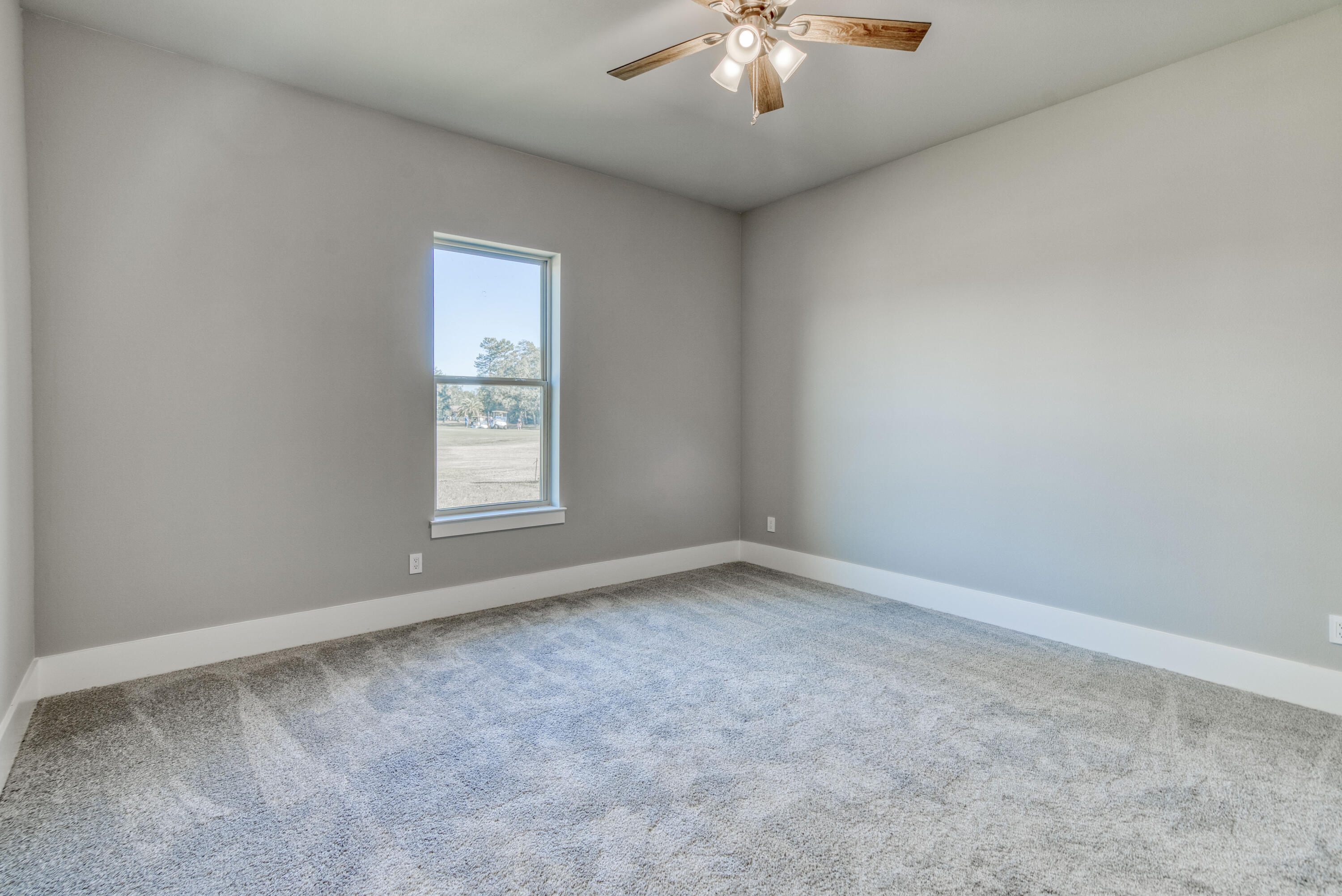 2864 P.G.A Boulevard Navarre, FL 32566 - Photo 31 of 52 an empty room with a chandelier fan