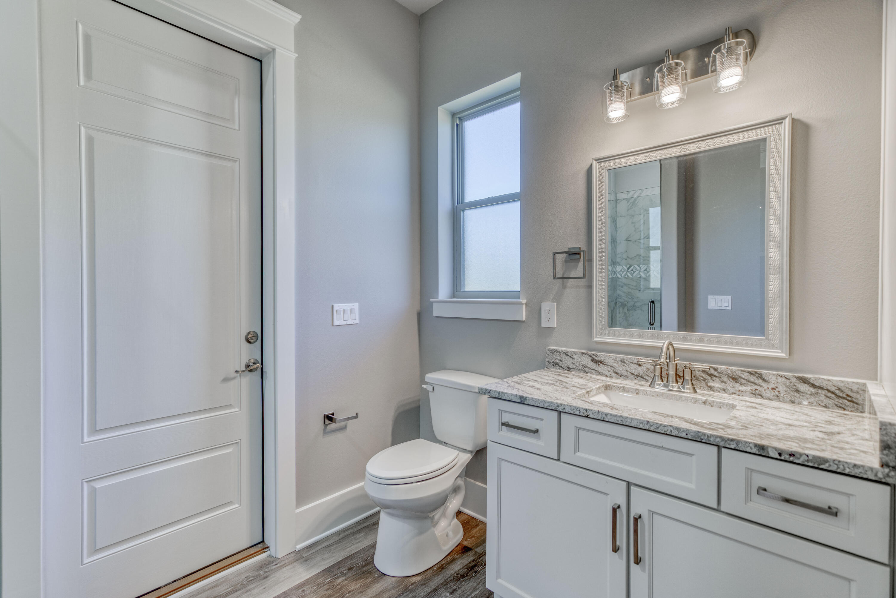 2864 P.G.A Boulevard Navarre, FL 32566 - Photo 33 of 52 a bathroom with a granite countertop sink toilet and shower