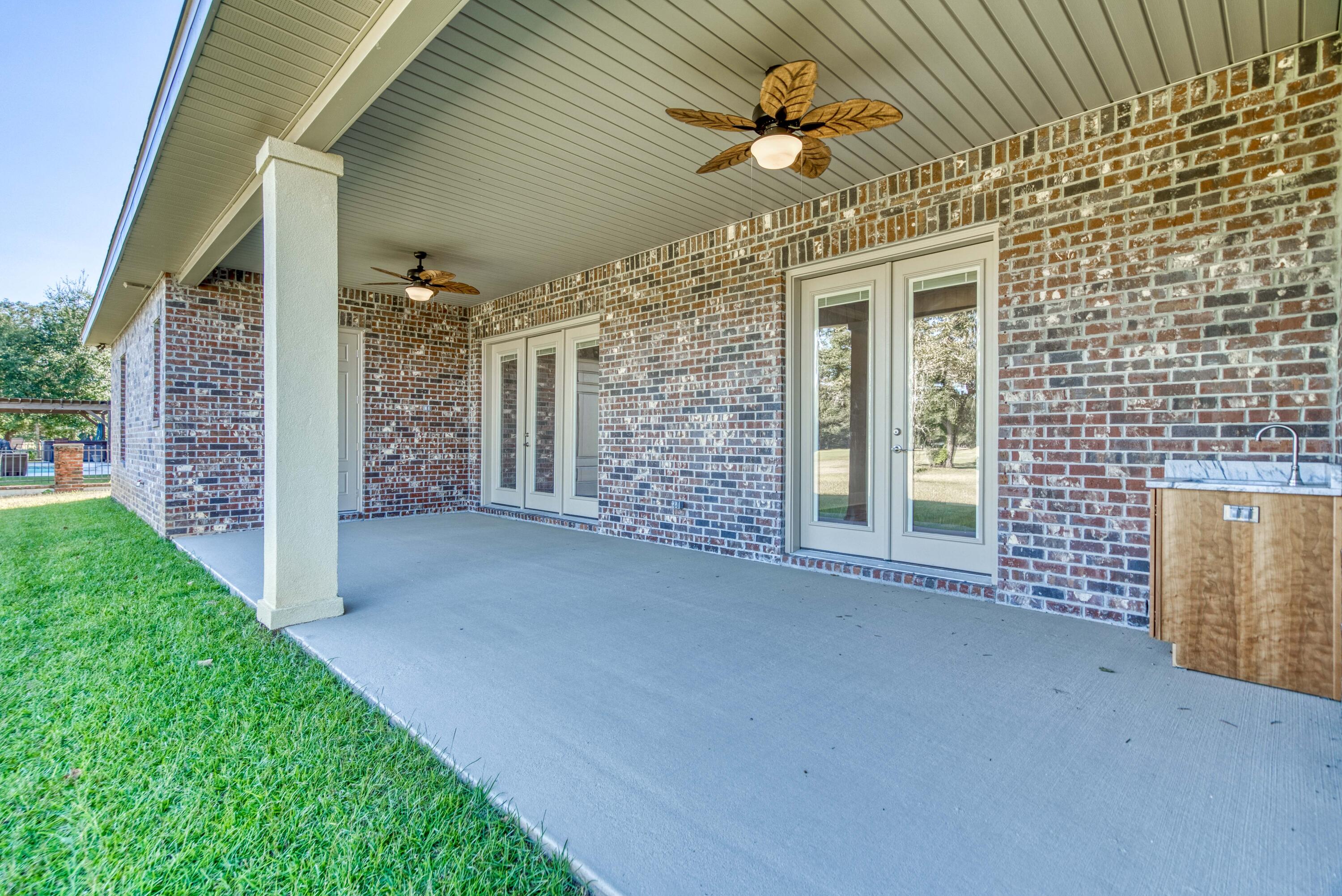 2864 P.G.A Boulevard Navarre, FL 32566 - Photo 40 of 52 a view of a porch with a table and chairs