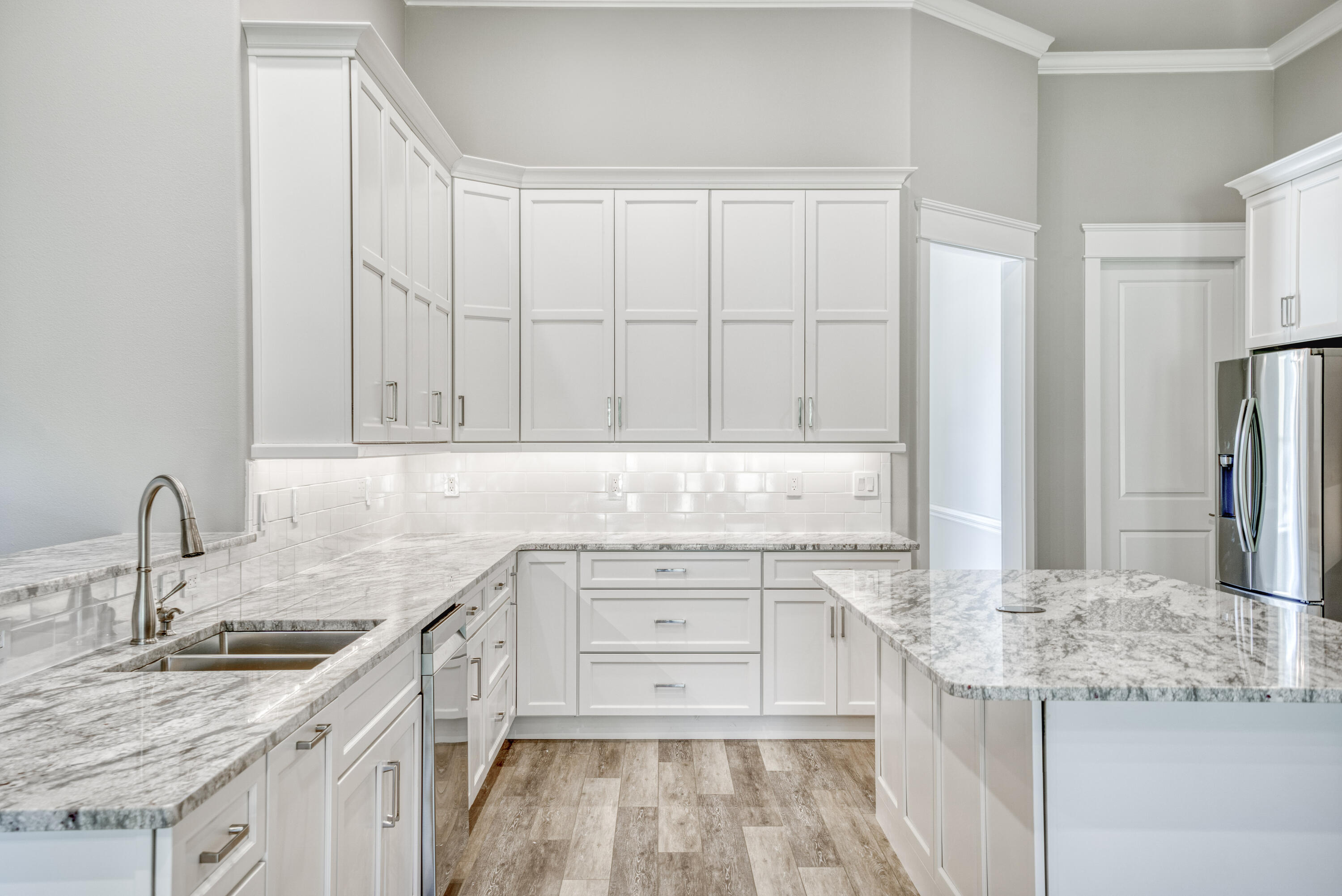 2864 P.G.A Boulevard Navarre, FL 32566 - Photo 7 of 52 a kitchen with a sink stove and cabinets