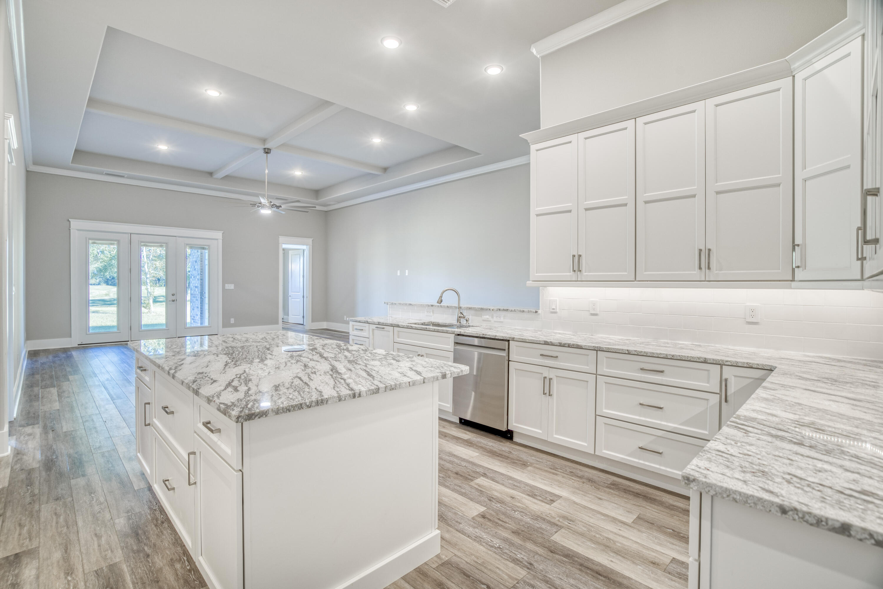 2864 P.G.A Boulevard Navarre, FL 32566 - Photo 10 of 52 a kitchen with granite countertop white cabinets and white appliances