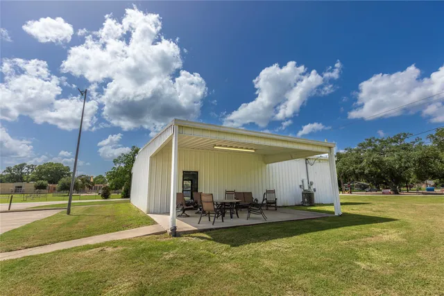 a view of a house with swimming pool and sitting area