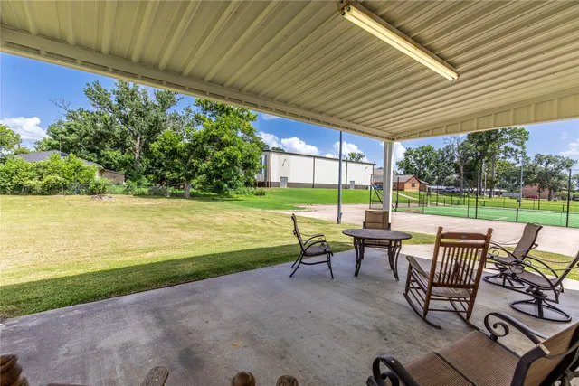 a view of a swimming pool with chair and table in the patio