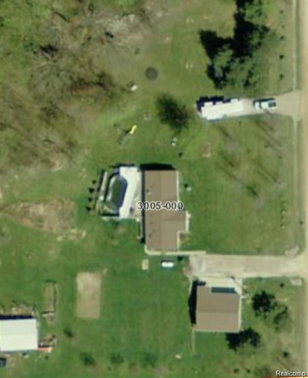 2611 Miller Road Allenton, MI 48002 - Photo 41 of 41 Aerial Image. Depicting the property from an overhead perspective, including a residential structure, an outbuilding, and surrounding land