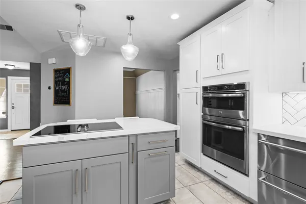 a kitchen with a sink and stainless steel appliances