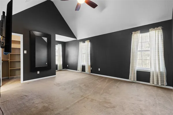 an empty room with windows and closet