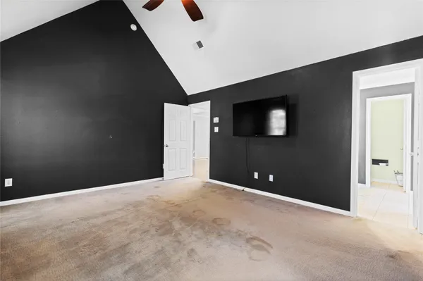 a view of a livingroom with a ceiling fan and window