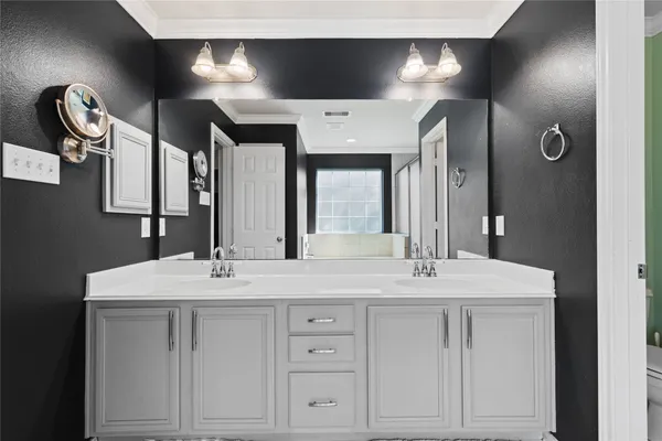 a bathroom with a double vanity sink and a mirror