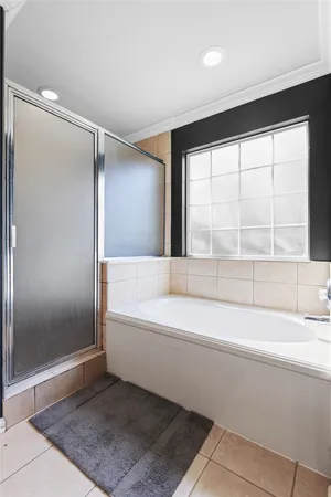 a bathroom with a bathtub and a shower