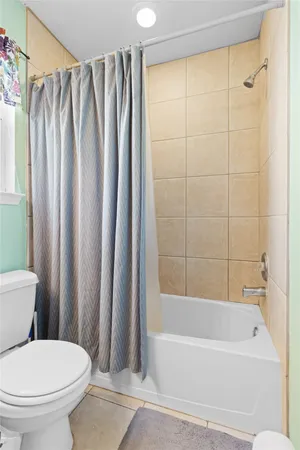 a bathroom with a toilet and a bathtub