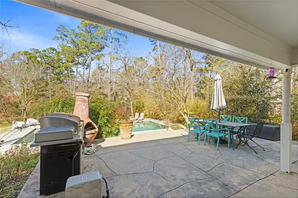 a view of a patio with table and chairs and potted plants