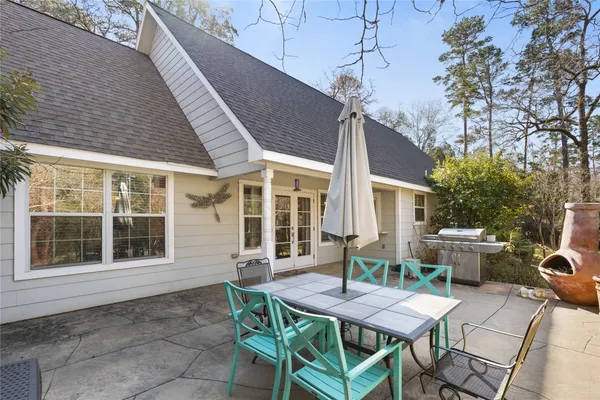 a view of a house with backyard and sitting area
