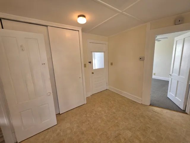 a view of an empty room with a mirror